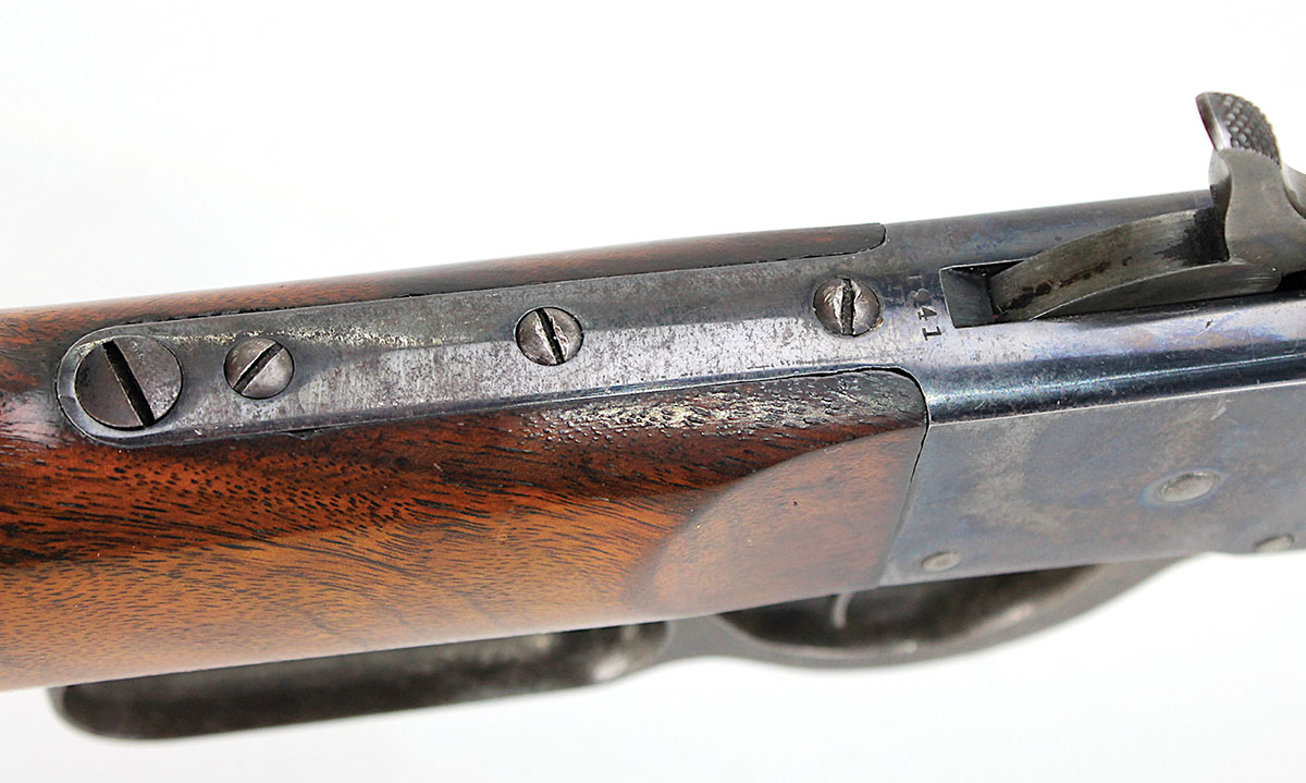 Three threaded screw holes in the upper tang permit mounting several different aperture sights.